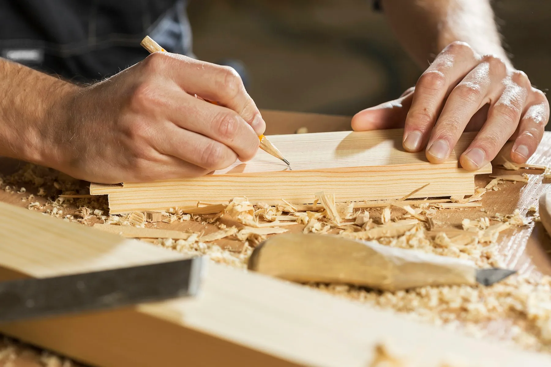 Hands marking an oak board
